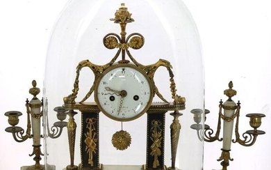 Louis XVI style mantel set in white alabaster, black marble and gilded bronze comprising a glass globe clock (H 45 cm) and blackened wood base (H 55 cm) and a pair of two-armed candelabra, H 29.5 cm. Enamelled dial signed "Collard à Paris". Thread...