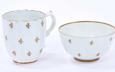 Lowestoft coffee cup, of faceted form with scrolled handle and a shaped rim picked out in gold, gilded with regularly spaced sprigs, 6.7cm high, and a tea bowl of plain form, with similar decoratio...
