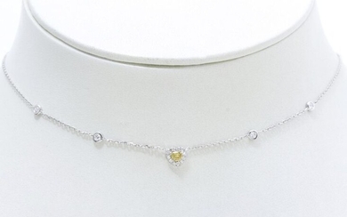 Necklace in white gold 750 thousandths retaining a pear facetted diamond ''Fancy yellow'' in claw setting surrounded and embellished with brilliant diamonds some of which in closed setting. Necklace adorned with a lobster clasp with adjusting rings.