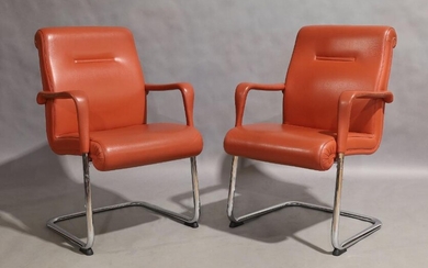 Poltrona Frau, a pair of cantilever armchairs, circa 1990, with vermillion leather seats on chromed metal supports, manufacturers label to underside, and mark stamped to leather, 92cm high, 61cm wide (2)