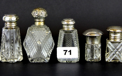 Seven hallmarked silver and cut glass perfume bottles, tallest H. 10cm.