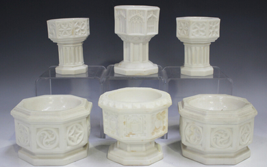 Six Parian travelling fonts, including a pair of octagonal form with moulded Gothic roundels by Thom