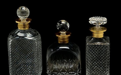 Three Cut Crystal Decanters with Gilt Rims.