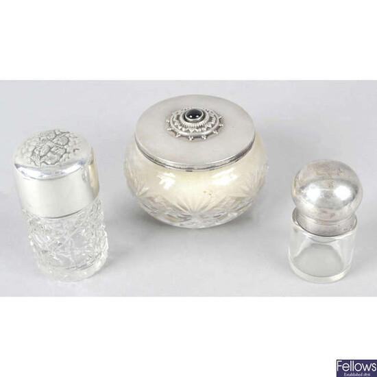 Two silver topped glass perfume bottles, a silver mounted ring tree (a.f), a bud vase (filled base), and a silver lidded glass powder bowl. (5).