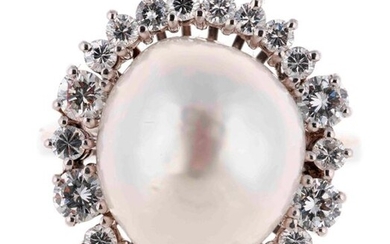 White gold ring centered on a baroque gold pearl in...