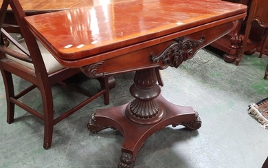 William IV Mahogany Card Table, the hinged top above a carved frieze, on turned reeded pedestal & quadraform base