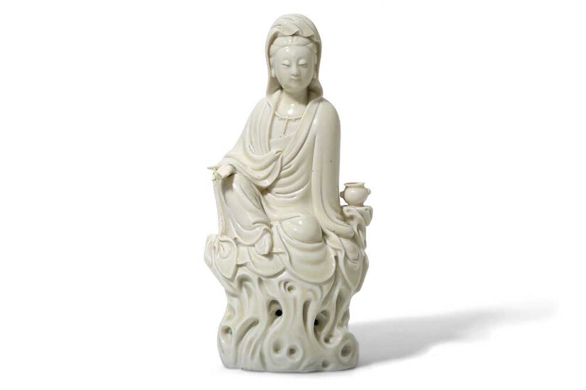 A CHINESE BLANC-DE-CHINE FIGURE OF GUANYIN. Qing Dynasty. Seated...