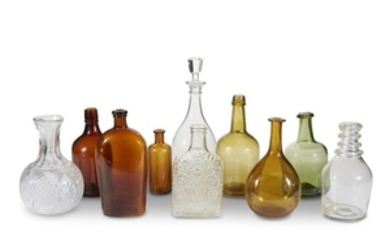 A collection of ten glass bottles and decanters late...