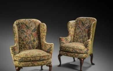 A pair of George I walnut wing armchairs, later up…