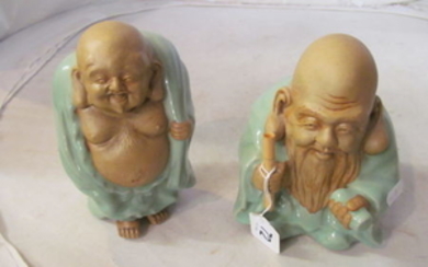 Two stoneware Buddha s with celadon coloured clothing