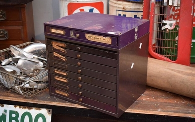A 1920s NINE DRAWER WATCHMAKERS STEEL CABINET COMPLETE WITH WATCH PARTS AND TOOLS