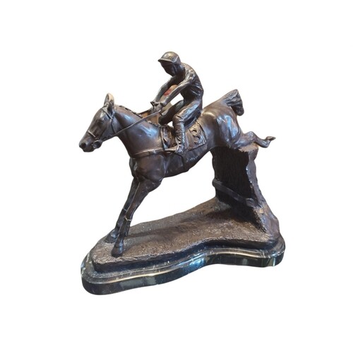 A BRONZE SCULPTURE OF A JUMPING HORSE AND JOCKEY The saddle ...