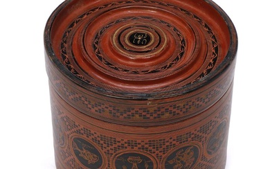 A Burmese lacquer betel box adorned with figures in roundels and design....