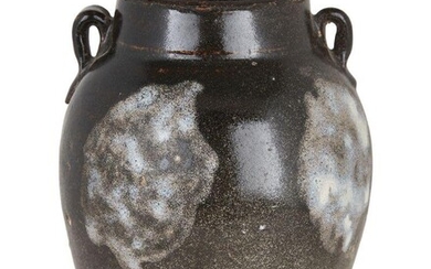 A Chinese Lushan phosphatic splash-glazed jar, Tang dynasty, with two ring handles, the exterior covered in a lustrous dark brown glaze decorated with milky-blue phosphatic splashes ending in an irregular line near the foot, 19cm high