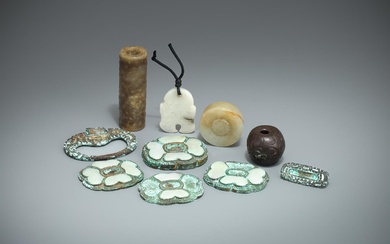A Chinese celadon and brown jade cylindrical toggle
