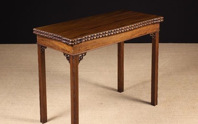 A Chippendale Style Mahogany Fold-over Card Table. The hinged top with carved egg & dart edge mouldi