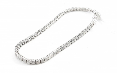 A DIAMOND LINE BRACELET - Comprising a row of round brilliant cut diamonds totalling 3.76cts, in 18ct white gold, total length 175mm.