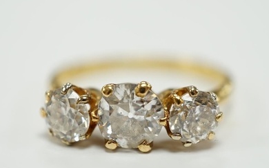A George V 18ct gold and three stone diamond set ring, the c...
