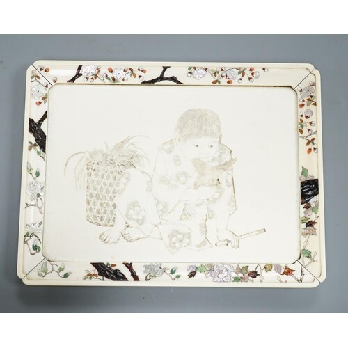 A Japanese ivory tray/plaque, Meiji period, with sunk-in car...