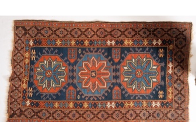 A North West Persian rug, the indigo field with triple rust ...