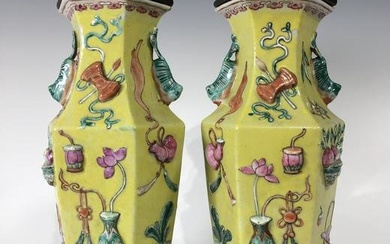 A PAIR OF CHINESE QING DYNASTY FAMILLE ROSE HIGH RELIEF YELLOW GROUND PORCELAIN VASES