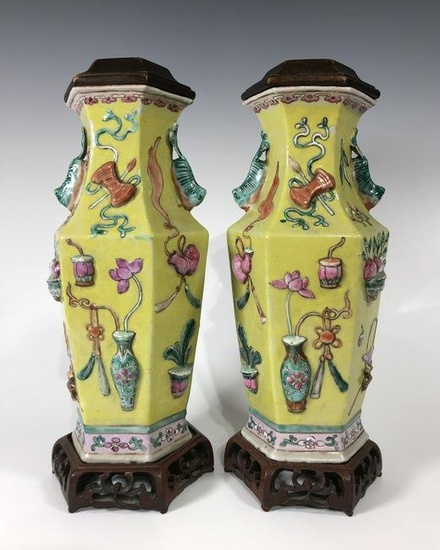 A PAIR OF CHINESE QING DYNASTY FAMILLE ROSE HIGH RELIEF YELLOW GROUND PORCELAIN VASES