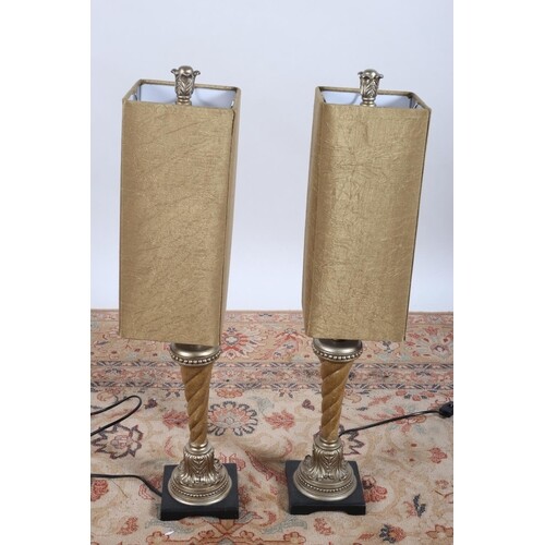 A PAIR OF CONTINENTAL AND GILT AND EBONISED TABLE LAMPS each...