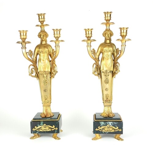 A PAIR OF EMPIRE STYLE GILT BRONZE FIGURAL THREE BRANCH CAND...