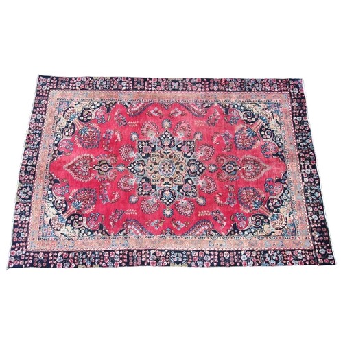 * A Persian pattern wool rug, the central eight branch blue ...