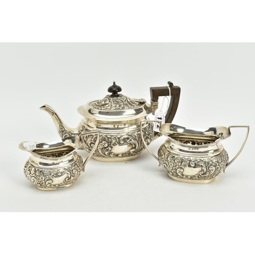 A SILVER THREE PIECE TEA SET, to include a floral embossed, ...