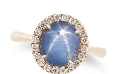 A STAR SAPPHIRE AND DIAMOND RING set with a round cabochon star sapphire of 6.16 carats in a border