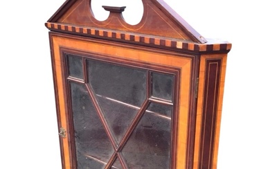 A Victorian mahogany hanging corner cabinet with broken pediment and...