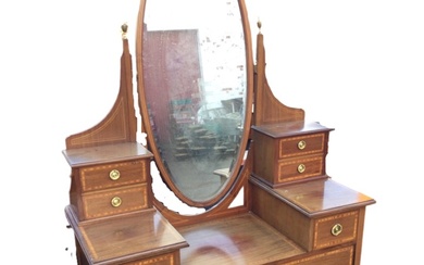 A Victorian mahogany satinwood banded dressing table, with oval bevelled...