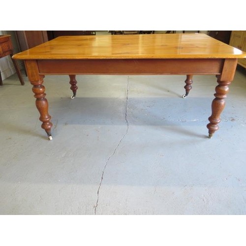 A Victorian pine and mahogany kitchen table on turned legs, ...