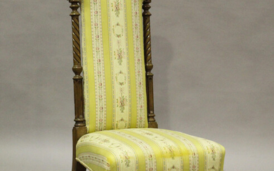 A Victorian rosewood framed prie-Dieu chair, upholstered in striped damask, raised on finely reeded