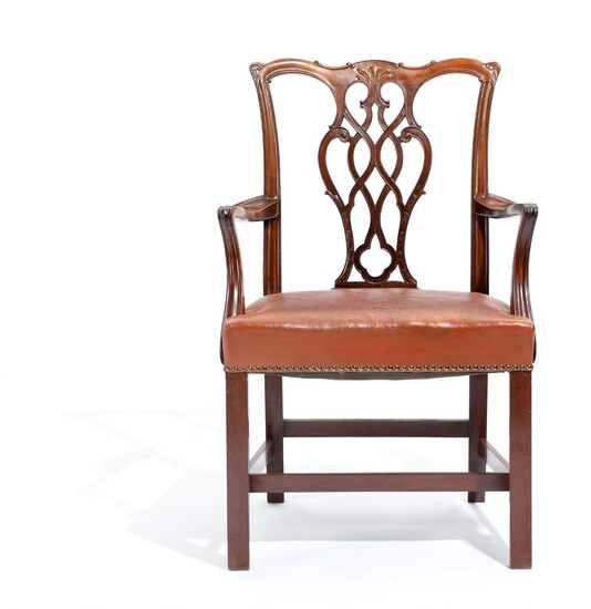 NOT SOLD. A circa 1900 nut and mahogany armchair, back with carvings, seat with leather...