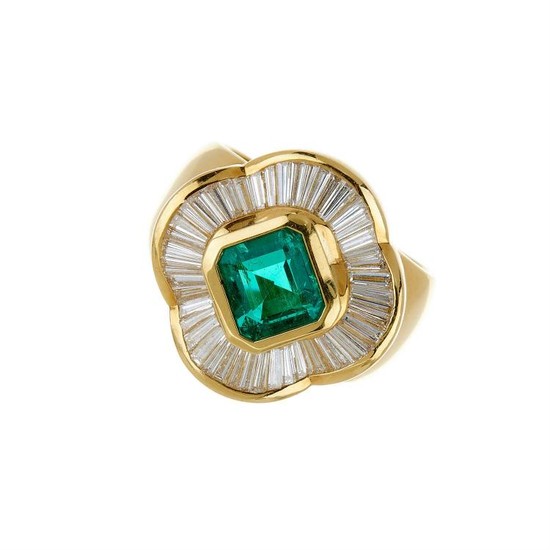 A diamond and emerald ballerina dress ring