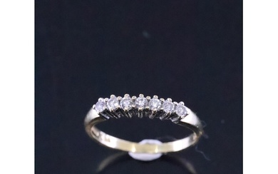 A diamond set 7 stone ring set in 18ct gold finger size M