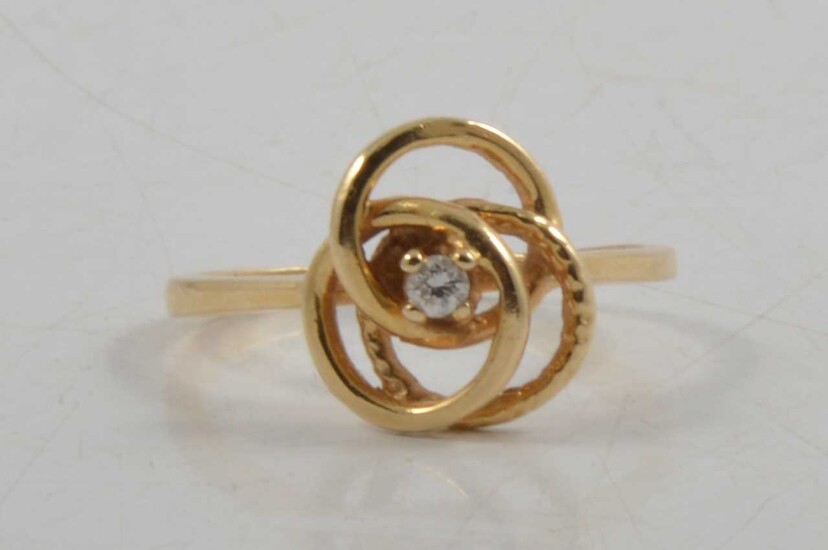 A diamond set knot design dress ring.