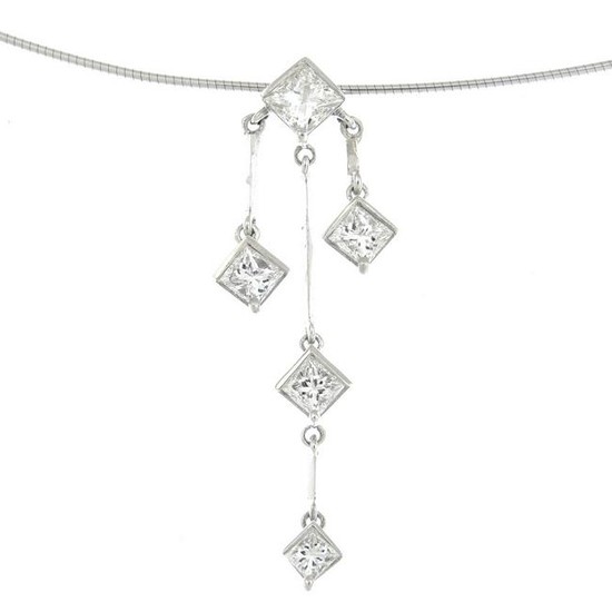 A diamond triple drop pendant, suspended from an 18ct