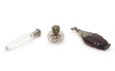A group of three silver mounted and glass scent bottles