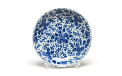 A large blue and white porcelain dish painted with floral design