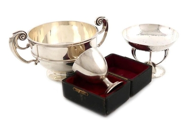 A mixed lot of silver items, comprising: an Edwardian tazza, by J. Carrington, London 1905, circular form, spot-hammered decoration, on three Art Nouveau sinuous legs, on a circular foot, plus a two handled bowl, London 1904 and a cased egg cup...