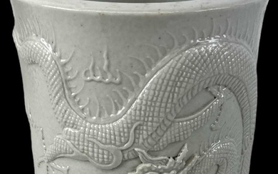 A modern Chinese brush pot decorated with a dragon, four...
