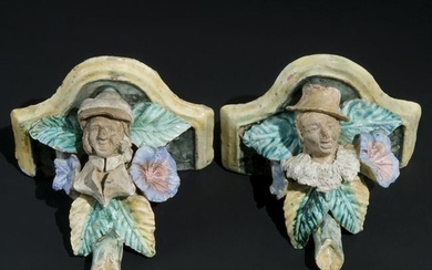 A pair of Art Nouveau polychrome ceramic shelves