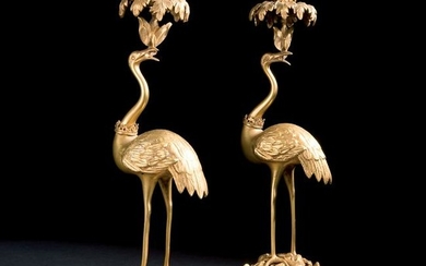 A pair of ormolu candlesticks in the shape of an heron