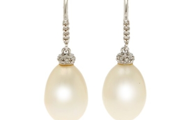 A pair of pearl- and diamond ear pendants, each set with a pear shaped cultured pearl and numerous brilliant- cut diamonds, mounted in 14k white gold.