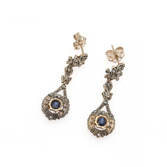 A pair of sapphire and diamond ear pendants each set with a circular-cut sapphire and numerous rose-cut diamonds, mounted in 14k gold and silver. (2)
