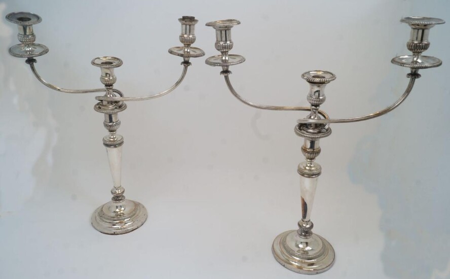 A pair of silver plated candelabra candlesticks, each detachable three branch upper section designed with reeded branches to gadrooned capitals and drip pans, approx. 51.5cm high (pr)