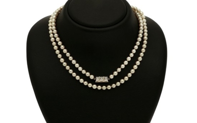 A pearl and diamond necklace of numerous cultured pearls and a pendant set with five brilliant-cut diamonds, mounted in 18k white gold. L. 88 cm.
